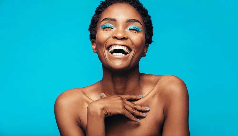 Smiling woman with bright blue lashes